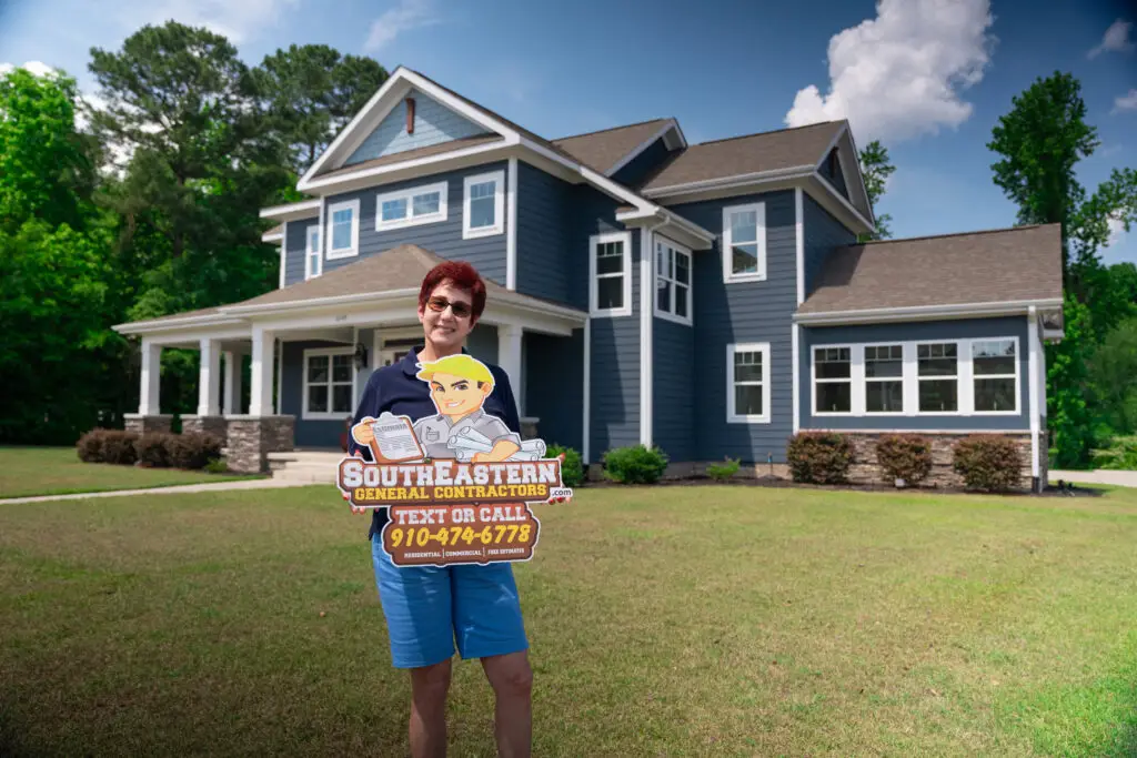 Day's Residence Builds Custom Home in Fayetteville NC Holding SEGC Sign, Happy Customer.