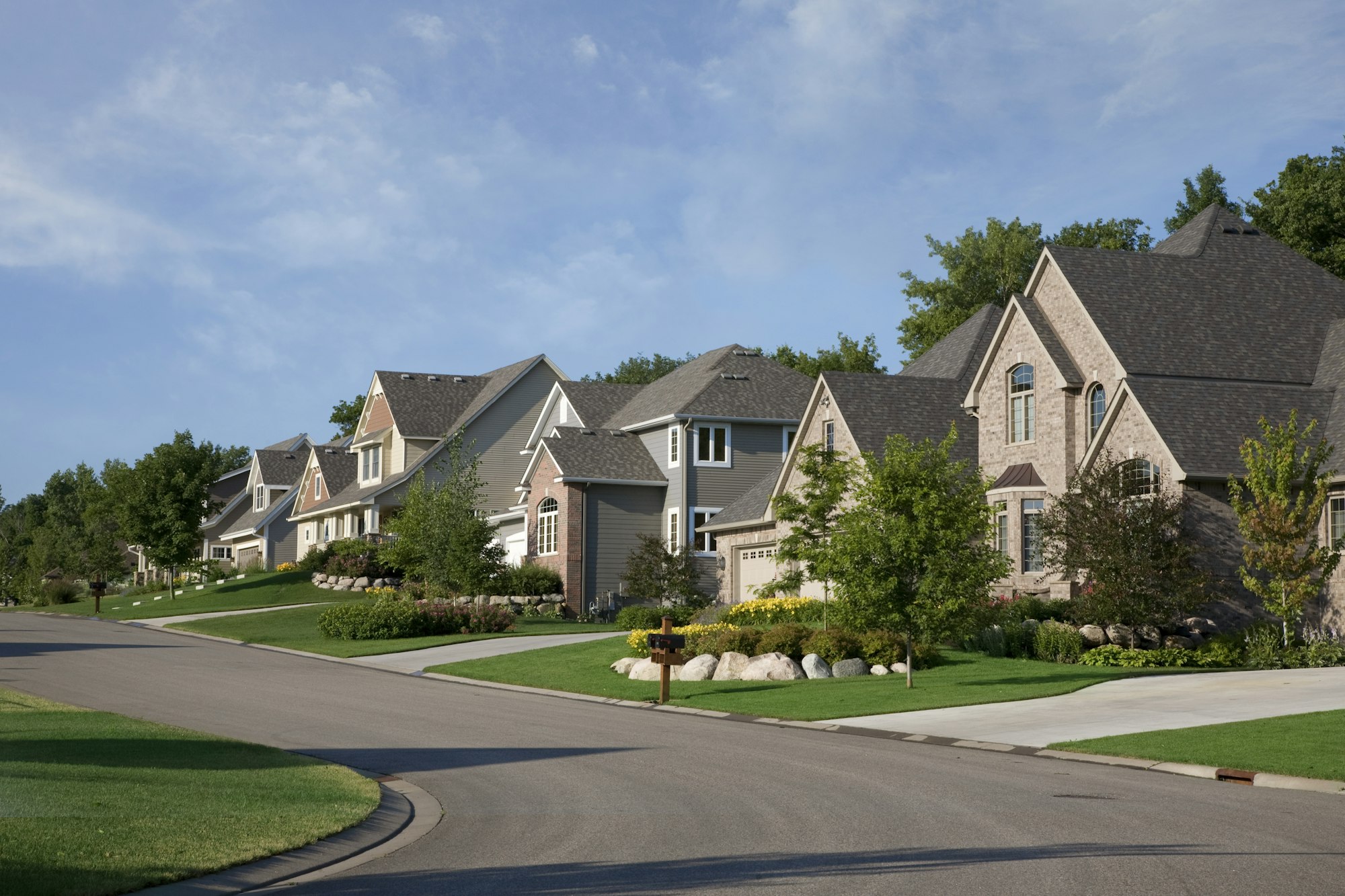 Street and houses of upscale neighborhood on a summer morning